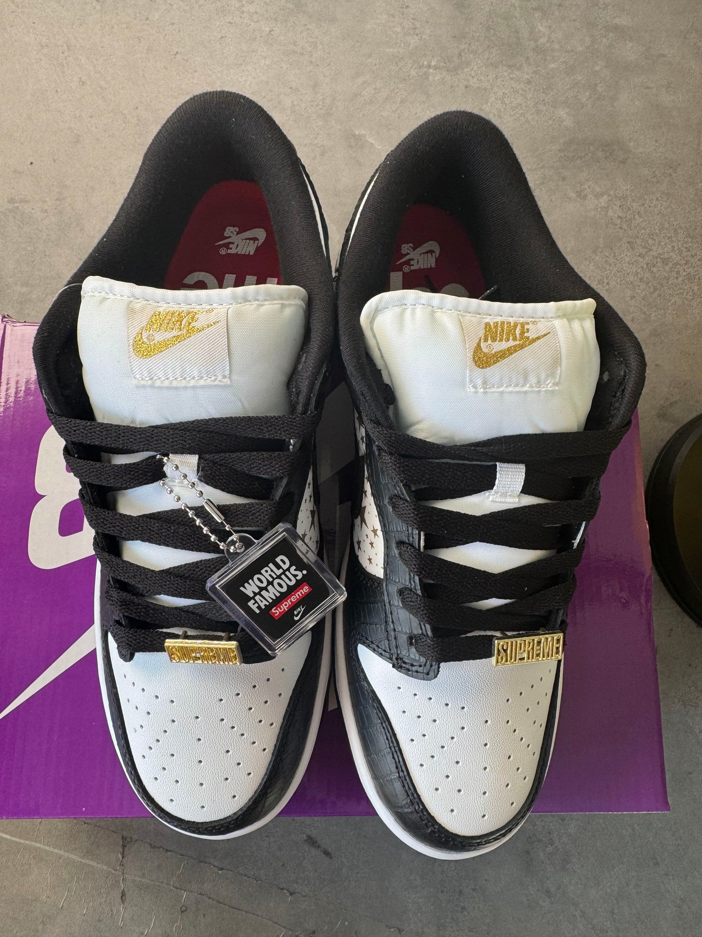 Supreme × Nike SB Dunk Low OG QS "Gold Stars" White/Black