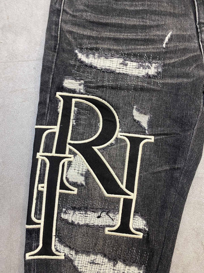 AMIRI jeans with a distressed finish, embroidered logo on the side