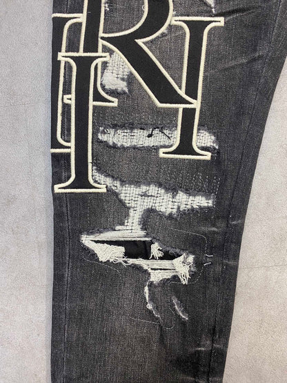 AMIRI jeans with a distressed finish, embroidered logo on the side