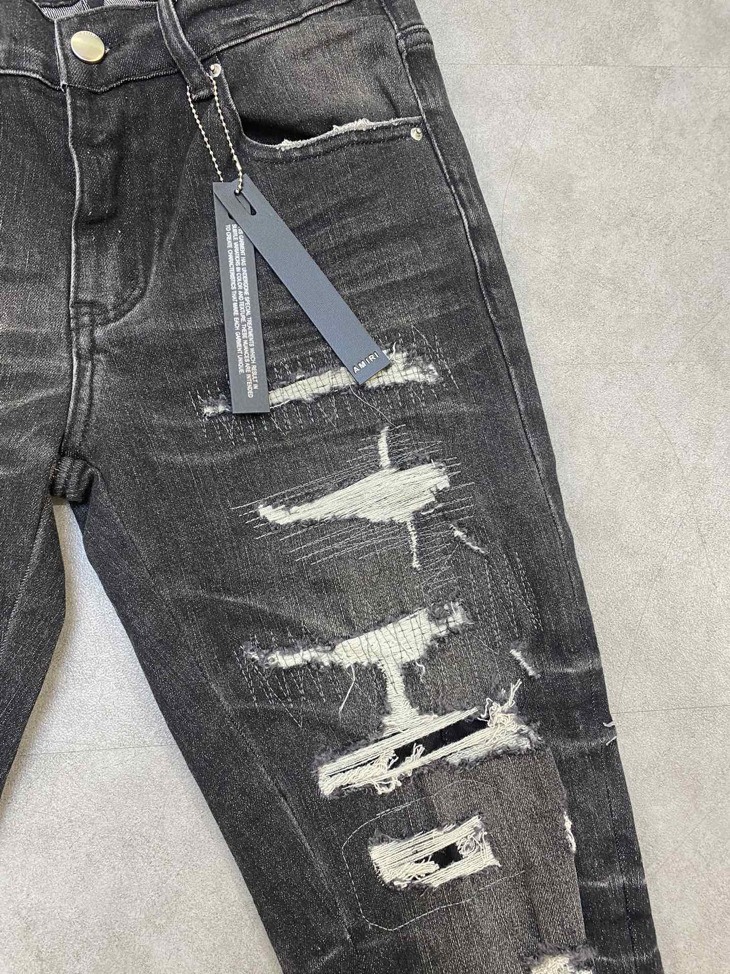 AMIRI jeans with a distressed finish, embroidered logo on the side