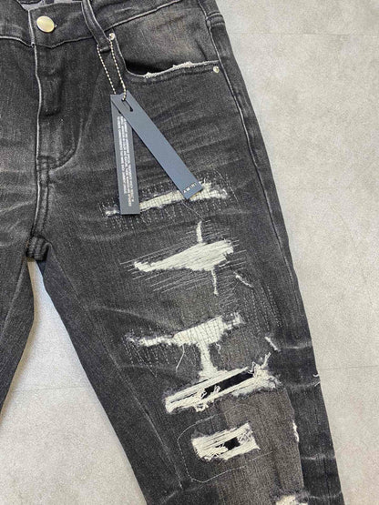 AMIRI jeans with a distressed finish, embroidered logo on the side
